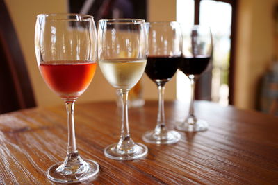 Close-up of wine glasses on table