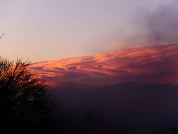 Low angle view of silhouette mountain against romantic sky