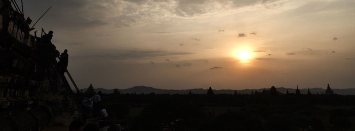 Silhouette people against sky during sunset