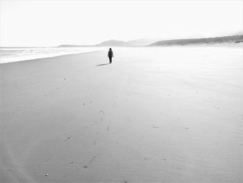 Full length of woman walking on beach