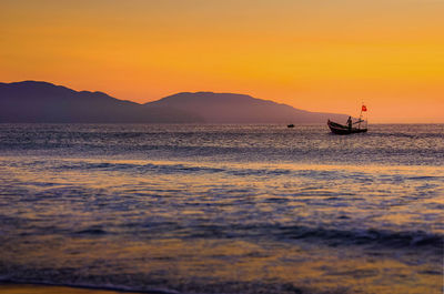 Scenic view of sea against orange sky