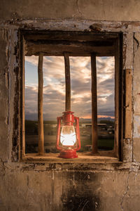 Illuminated electric lamp on window sill