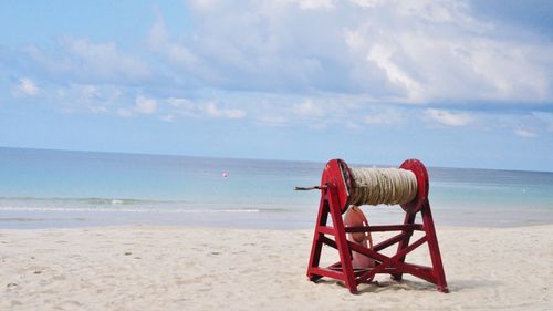 Lifeguard hut on beach against sky