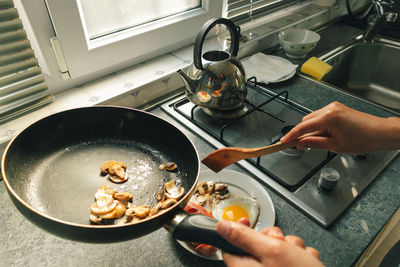 Midsection of woman preparing food in kitchen