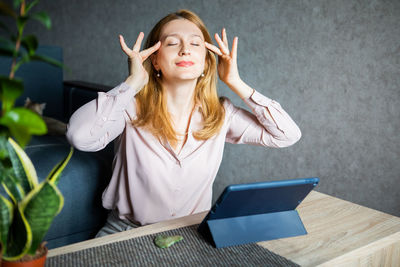 Portrait of young woman using digital tablet