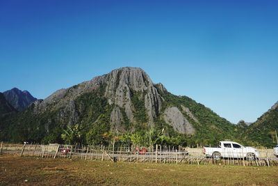 Scenic view of mountains against clear blue sky