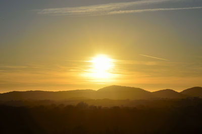 Scenic view of silhouette mountains against sky during sunset