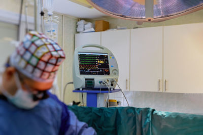 Defocused image of surgeon performing surgery in hospital