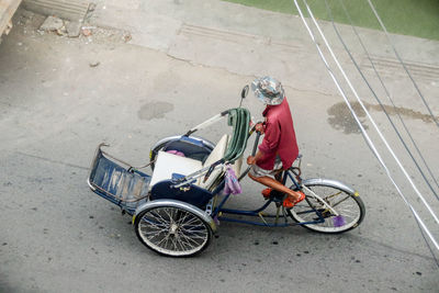 High angle view of man riding bicycle on road