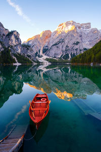 Scenic view of lake by mountain against sky