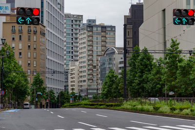 Road by buildings in city