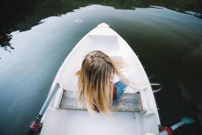 Rear view of woman on boat in water