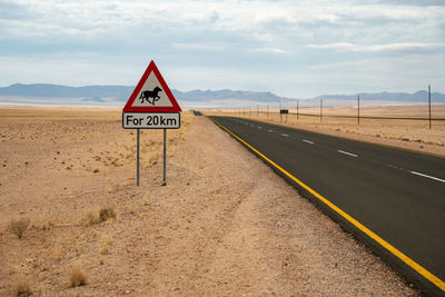 Attention wild horses traffic sign in namibia at a road