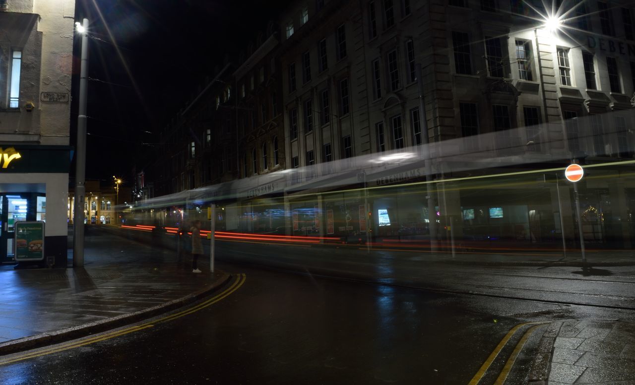 TRAIN ON ROAD AT NIGHT