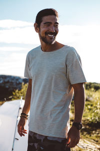 Man looking away smiling in a sunny day in a campsite