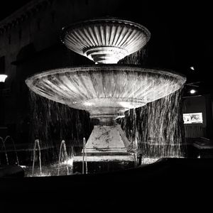 Illuminated fountain at night