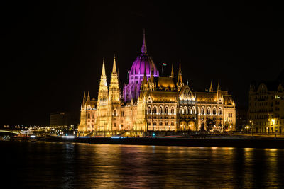 Illuminated city at waterfront