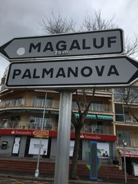 Low angle view of sign against sky