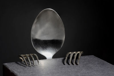 Close-up of forks and spoon against black background