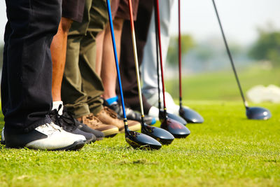 Low section of people standing on golf course