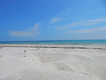 Scenic view of beach against blue sky