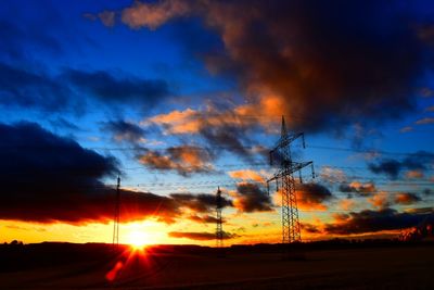 Silhouette of landscape against cloudy sky