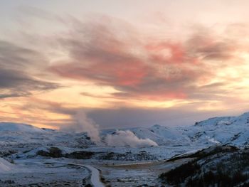 Scenic view of snowcapped mountains against sky during sunset