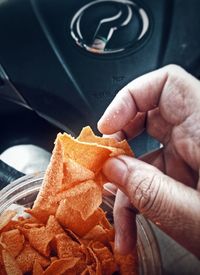 Close-up of hand holding ice cream cone in car