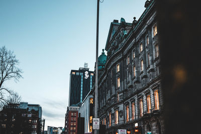 Low angle view of buildings against blue sky