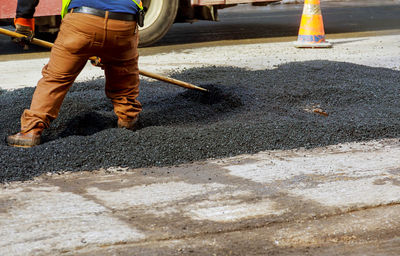 Low section of man working at construction site