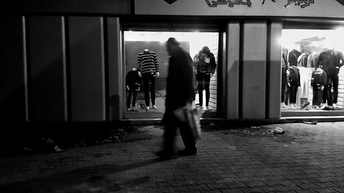 People walking on footpath in city