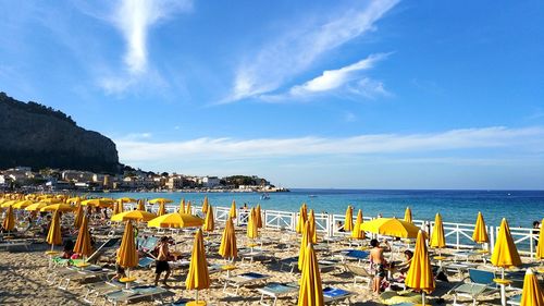 Scenic view of beach against blue sky