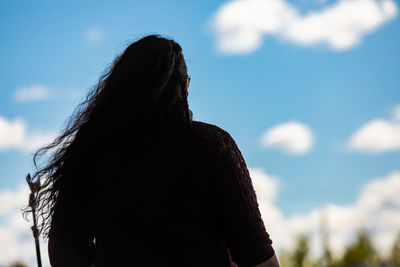 Rear view of woman looking at camera