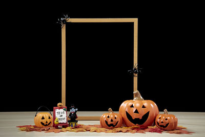 View of pumpkins against black background