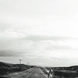 Road passing through landscape against sky