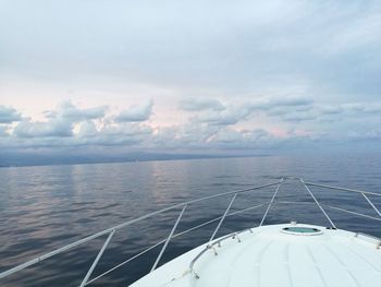 Cropped image of boat sailing on sea against sky