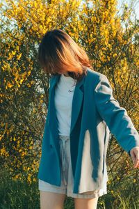 Midsection of woman standing on field during autumn