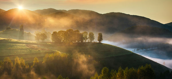 Scenic view of landscape against sky during sunrise