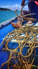 Close-up of fishing net in sea against sky
