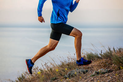 Low section of woman exercising on field