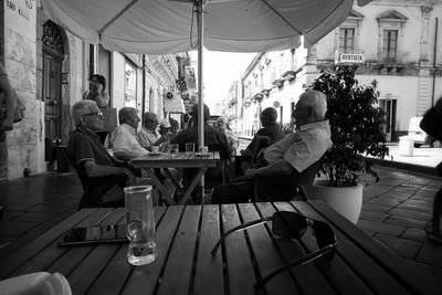 People sitting on table in city