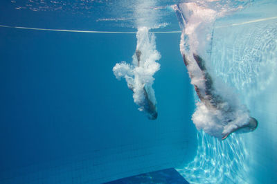 Man and woman swimming in pool 