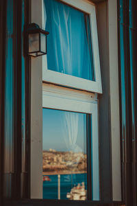 Blue sky seen through window of house