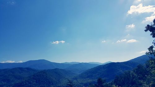 Scenic shot of mountain range against blue sky