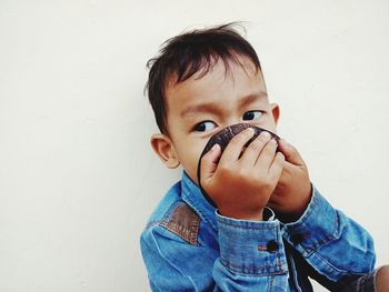 Portrait of boy against white background