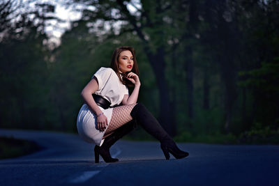 Portrait of young woman sitting outdoors