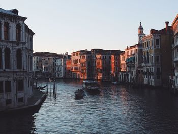 Boats in canal along buildings