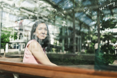 Portrait of smiling young woman sitting outdoors