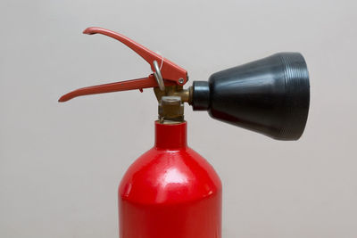 Close-up of red bottle against white background