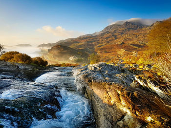 Scenic view of waterfall against sky